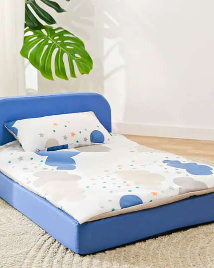 Children's inflatable bed with blue frame and cartoon design on mattress, indoor setting.