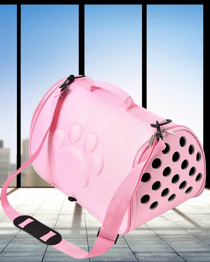 Pink pet carrier with black polka dots on a tiled floor with large windows in the background