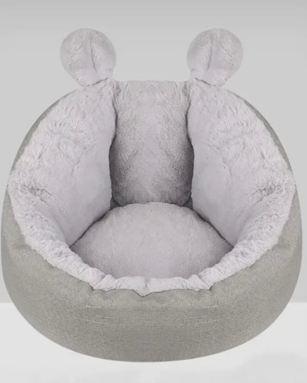Gray pet bed with round shape and soft texture on a white background