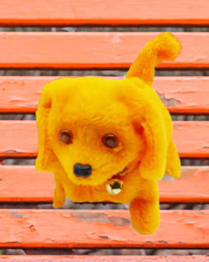 Yellow plush dog toy on a wooden bench