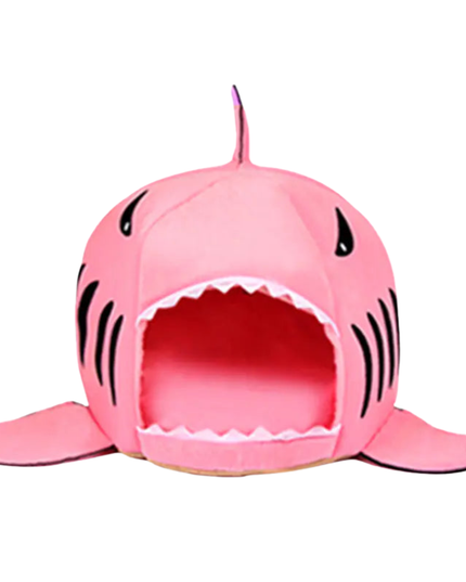Pink shark-shaped pet bed on a white background