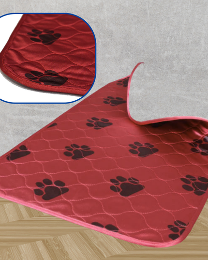 Red pet mat with black paw prints on a gray floor.