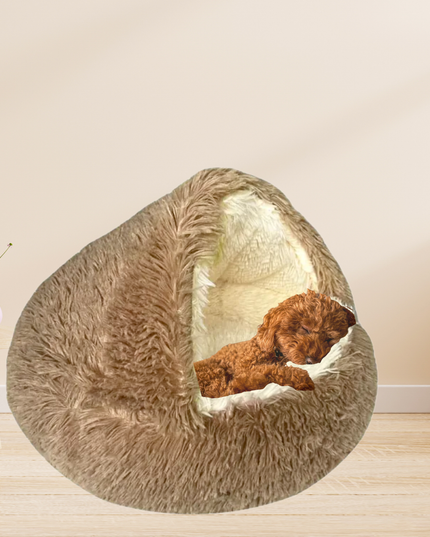 Fluffy pet bed with a dog inside on a wooden floor.