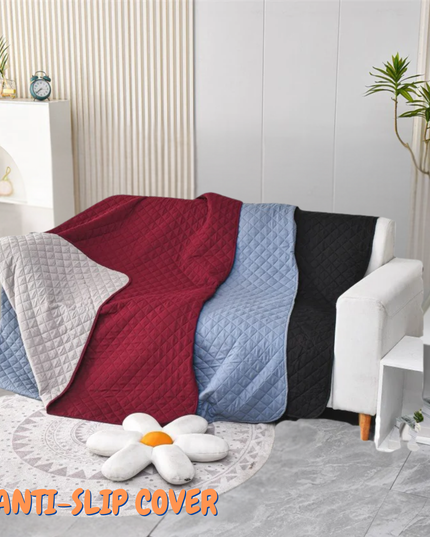 Four textured blankets in red, blue, gray, and black draped over a chair in a living room setting with 'Anti-Slip Cover' text.