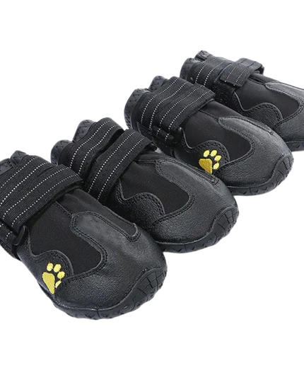 Set of black pet boots with yellow paw prints on a white background