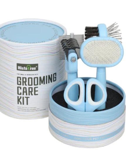 Pet grooming care kit with scissors, brush, and other tools in a cylindrical container on a white background.