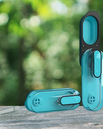 Turquoise window handles on a wooden surface with a blurred green outdoor background