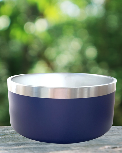 Gray bowl with silver rim on a wooden surface with a blurred green background
