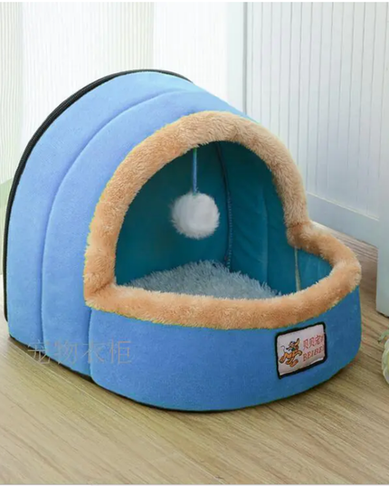 Blue pet bed with beige rim on a wooden floor