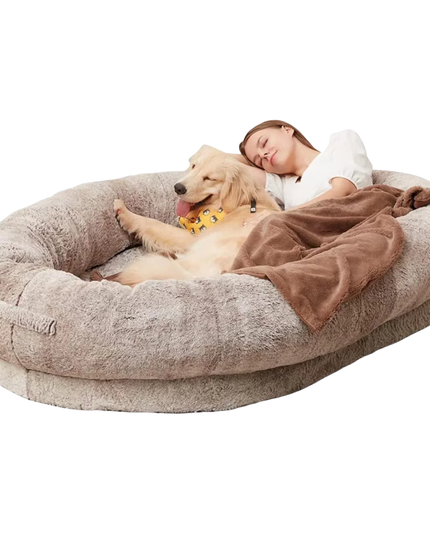 Large donut-shaped pet bed with a dog and person on a white background