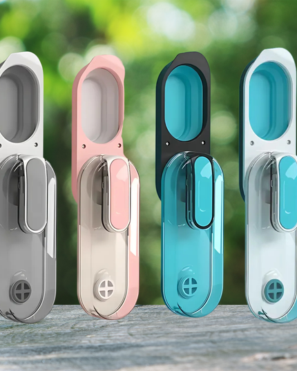 Four colorful door handles on a wooden surface with a blurred green background