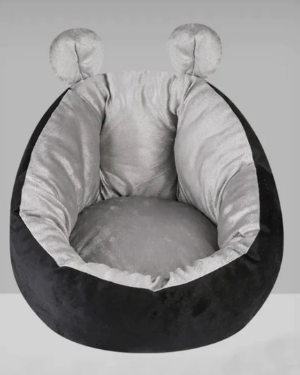 Round pet bed with black exterior and gray interior on a white background