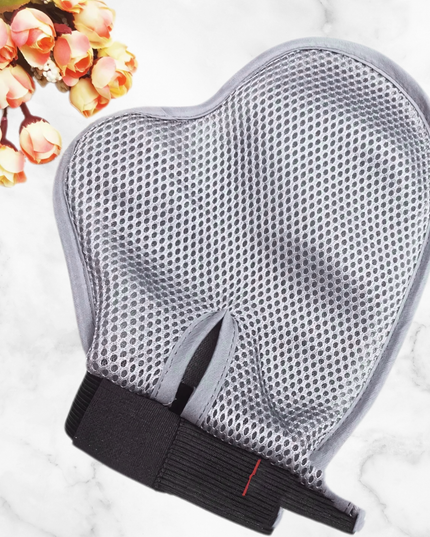 Gray mesh glove with black base on a marble surface with flowers in the corner
