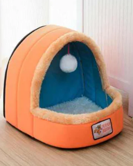 Orange pet bed with a blue interior on a wooden floor.