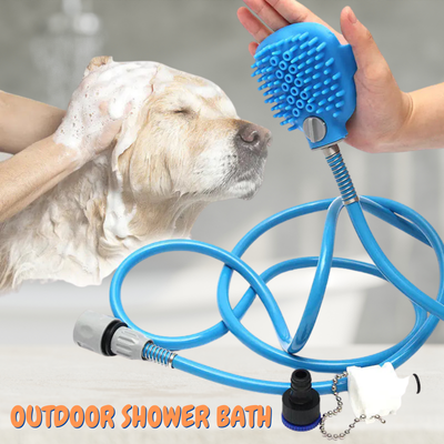 Dog being bathed with a blue outdoor shower bath system held by a person.