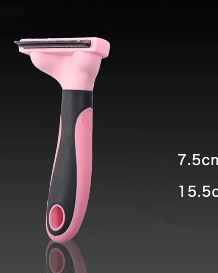 Pink and black pet grooming tool on a dark background with measurements indicated.