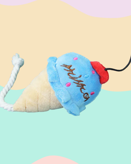 Plush ice cream cone toy with a blue scoop and red cherry on a colorful background