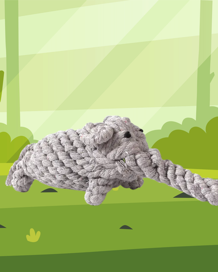 Gray rope toy shaped like a dog on a green forest background