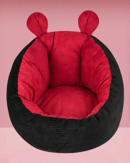 Black bean bag chair with red interior on a pink background