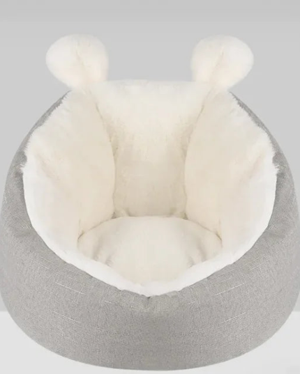 Gray pet bed with white interior on a light gray background