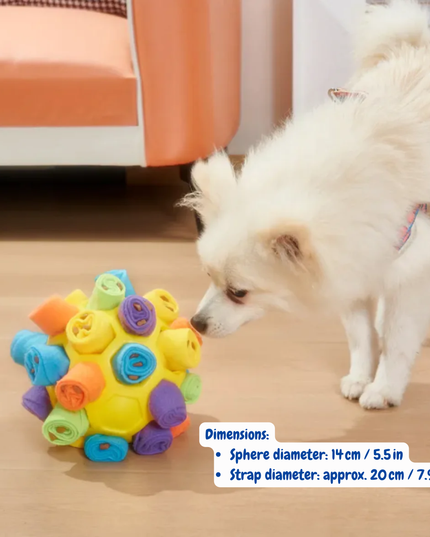 Dog playing with a colorful ball toy on a wooden floor.