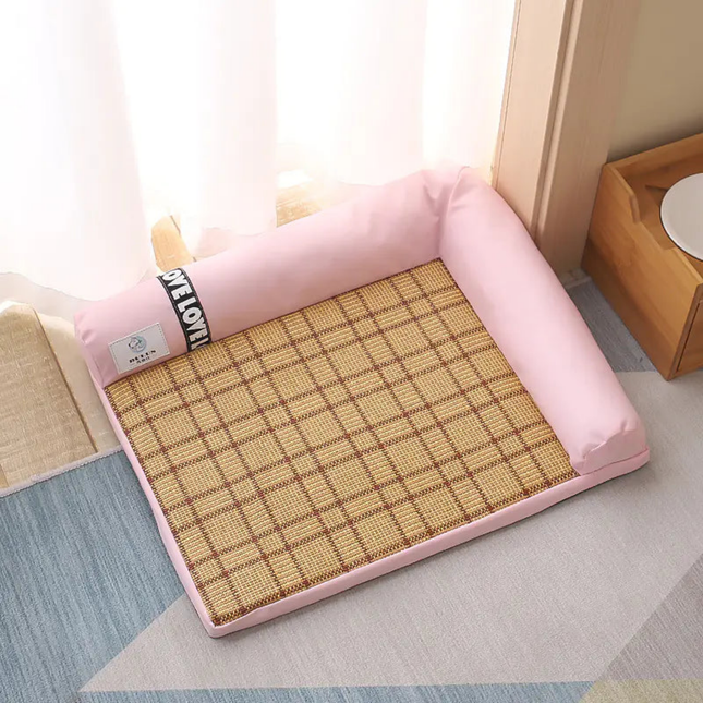 Pink cushion with a woven mat on a light-colored floor.