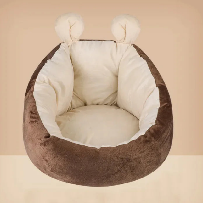 Brown pet bed with white cushion on a beige background