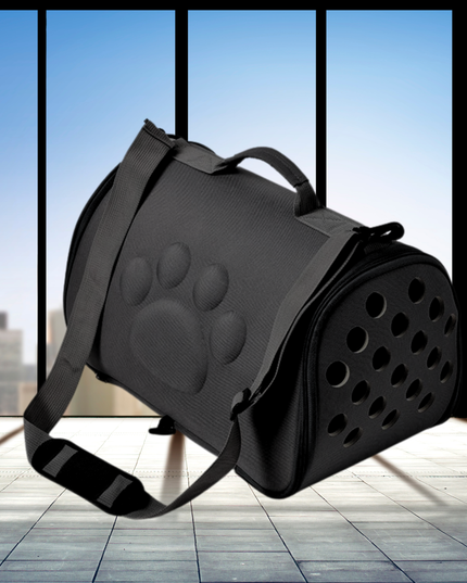 Black pet carrier with paw print design on a reflective floor with a cityscape background