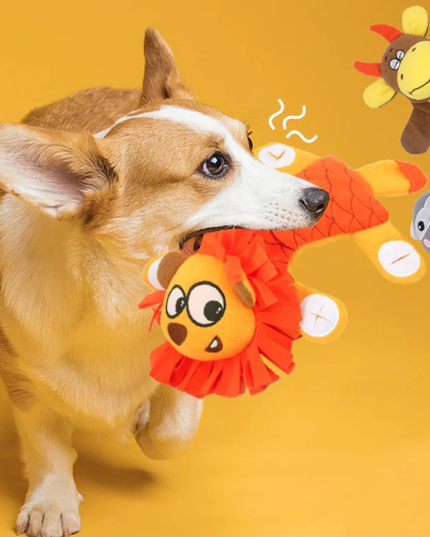Dog playing with a colorful toy on a yellow background