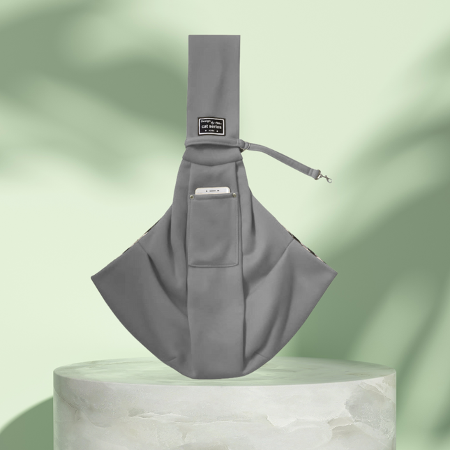 Gray sling bag on a light green background