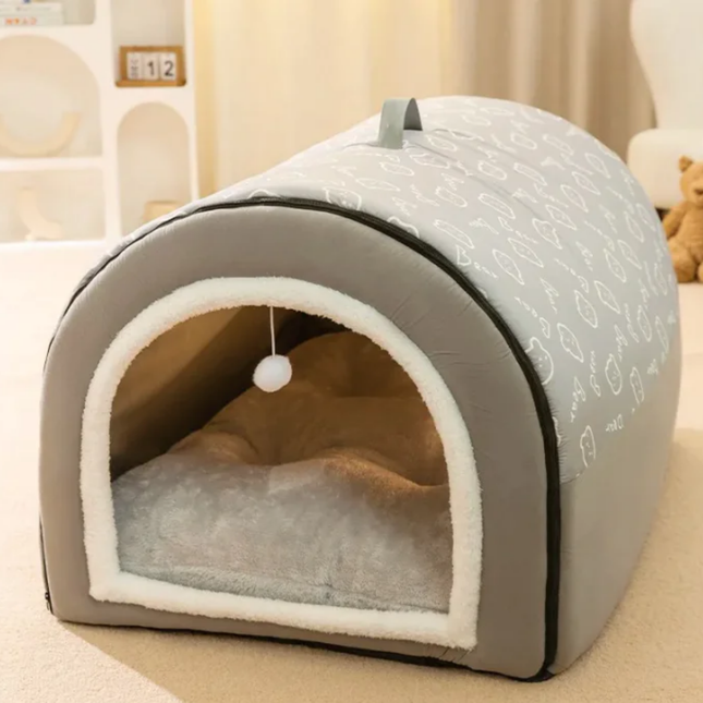 Gray pet bed with white interior on a beige surface