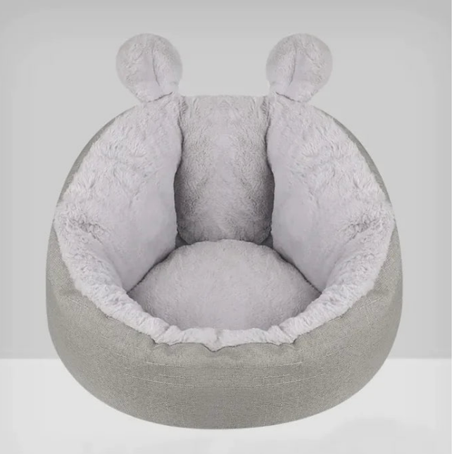 Gray pet bed with round shape and soft texture on a white background