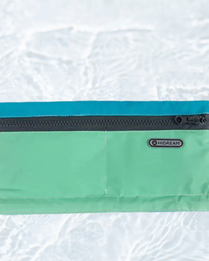 Green pouch with a zipper on a textured white background