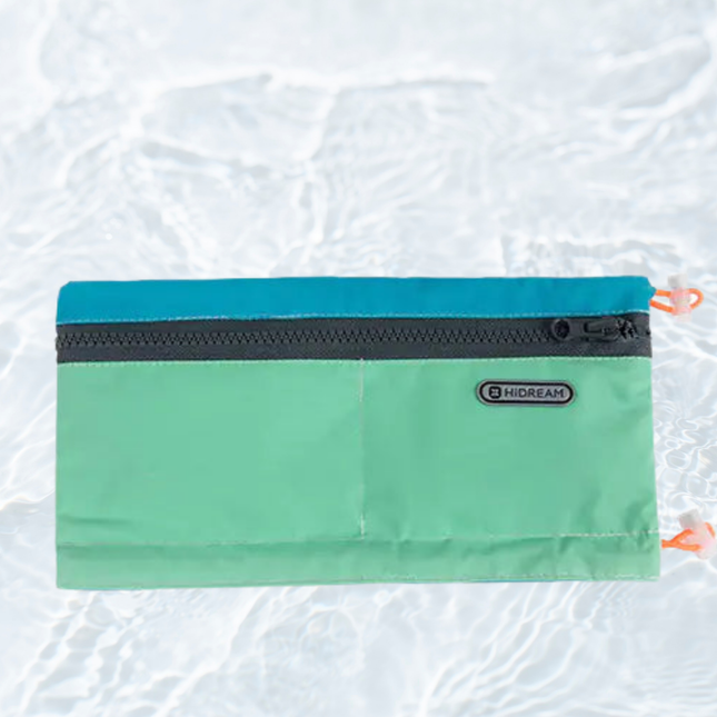 Green pouch with a zipper on a textured white background