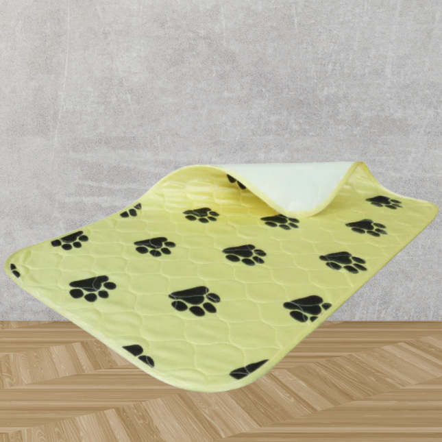 Yellow pet mat with black paw prints on a gray and wooden surface