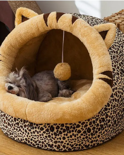 Pet bed with leopard print and plush interior, featuring a small dog inside.