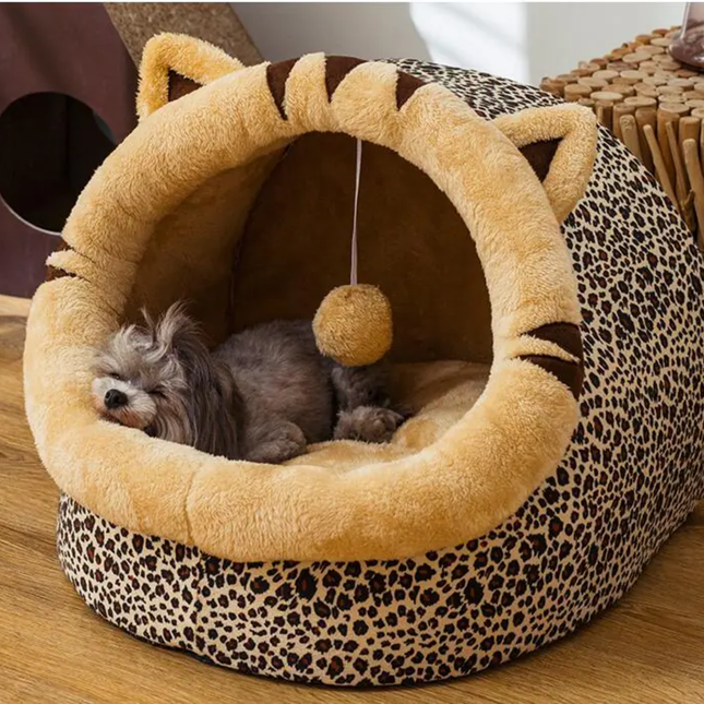 Pet bed with leopard print and plush interior, featuring a small dog inside.