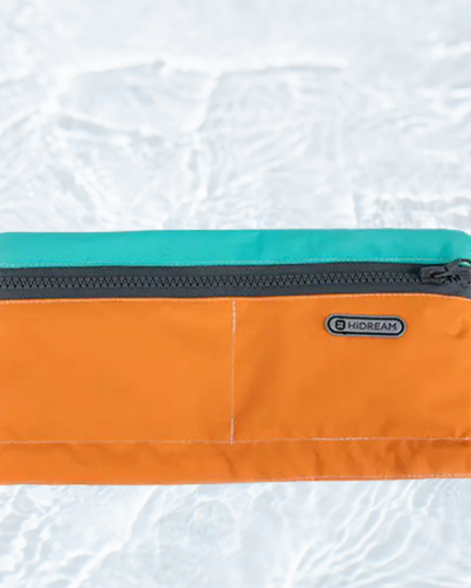Orange pouch with teal top section on a light gray background