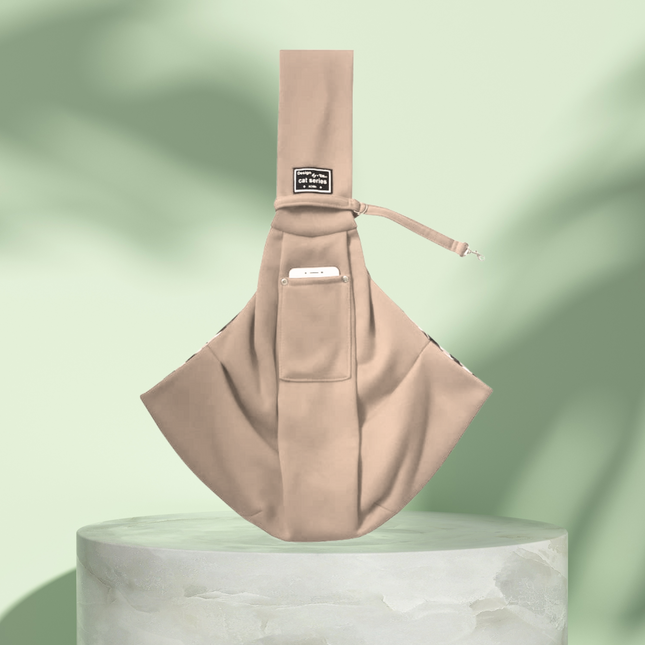 Beige sling bag on a light green background