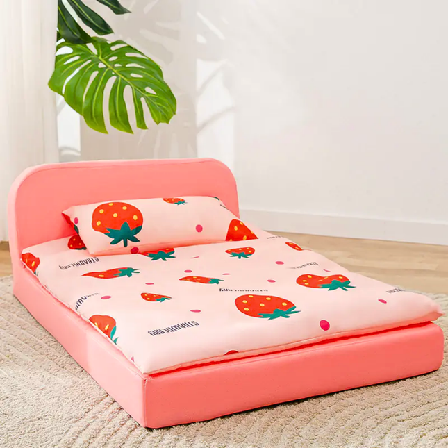 Pink children's bed with strawberry patterned bedding and pillow on a carpeted floor.