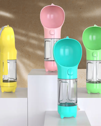 Four colorful pet water bottles on a reflective surface with a neutral background