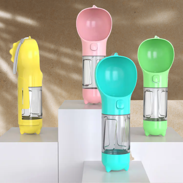 Four colorful pet water bottles on a reflective surface with a neutral background
