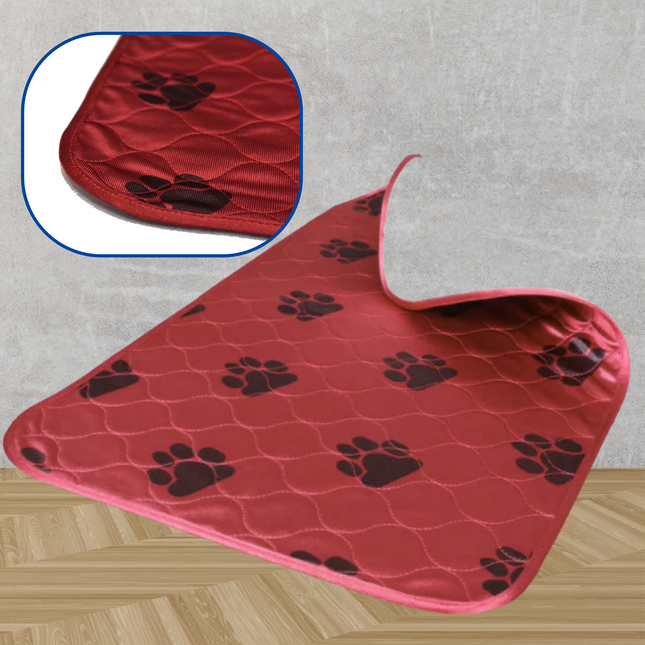 Red pet mat with black paw prints on a gray floor.