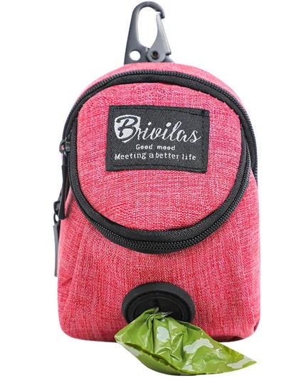 Pink pet waste bag dispenser with a green bag on a white background