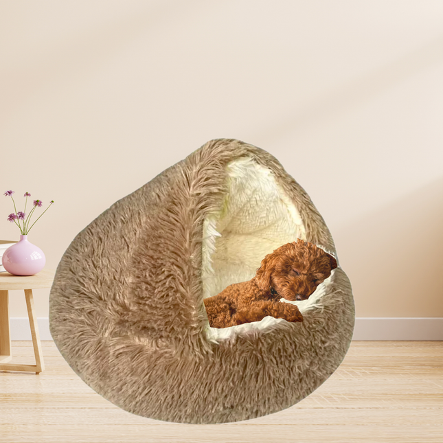 Fluffy pet bed with a dog inside on a wooden floor.