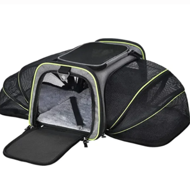 Black pet carrier with open door on a white background