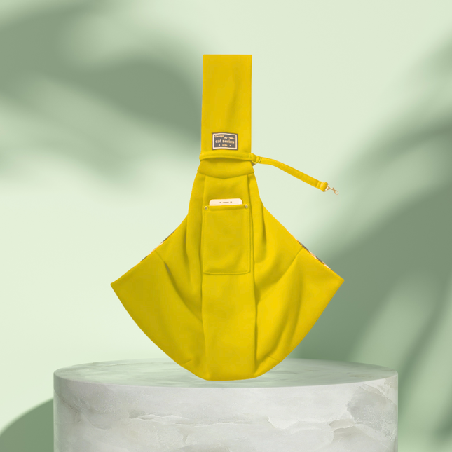 Yellow sling bag on a white pedestal with a light green background