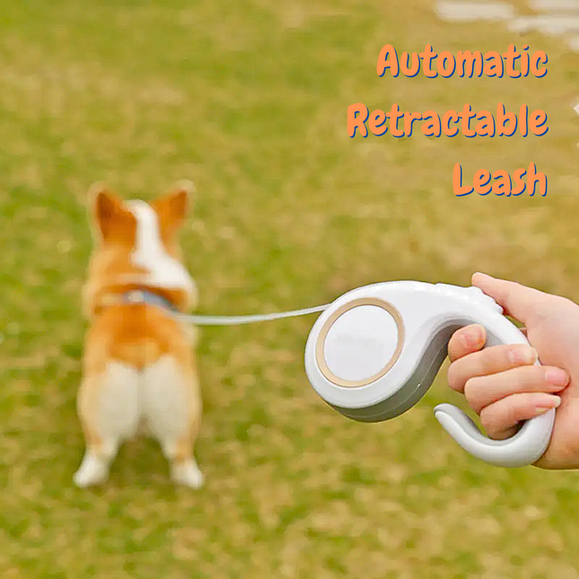 Person holding an automatic retractable leash with a dog on a grassy field