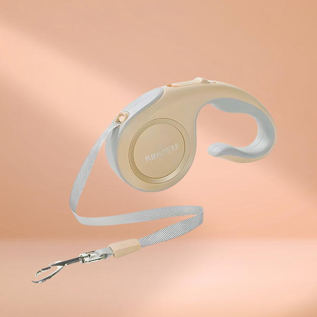 Retractable dog leash with beige handle on a peach background
