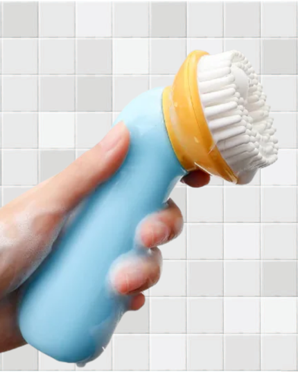 Hand holding a blue and yellow scrubbing brush against a tiled bathroom wall.